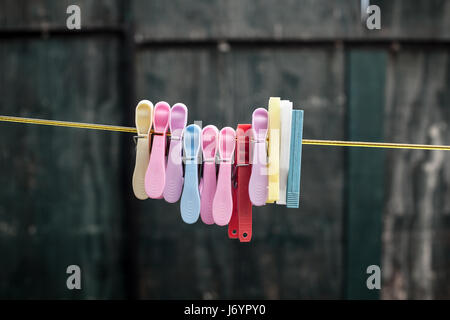 Multicolored Plastic Clothespins Hanging on a Wire Stock Photo