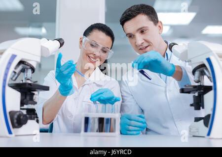 Positive delighted female working in laboratory Stock Photo