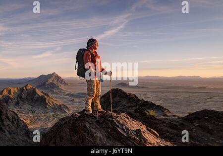 Hiker in the Mohawk Mountains at Sunset, Arizona, United States Stock Photo