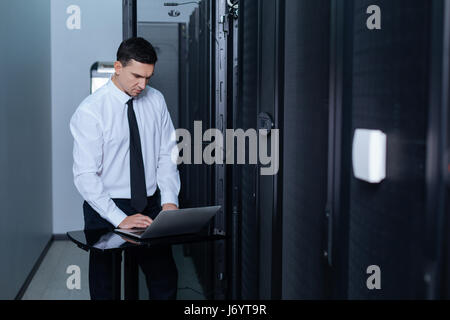 Handsome nice man working on a laptop Stock Photo