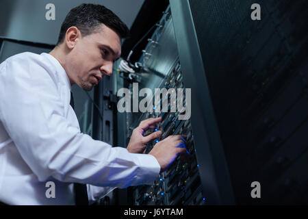 Professional computer engineer looking at the data server Stock Photo
