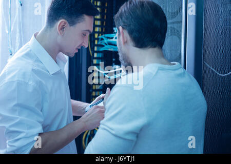 Nice male colleagues working together Stock Photo