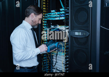 Professional handsome engineer doing a system check Stock Photo