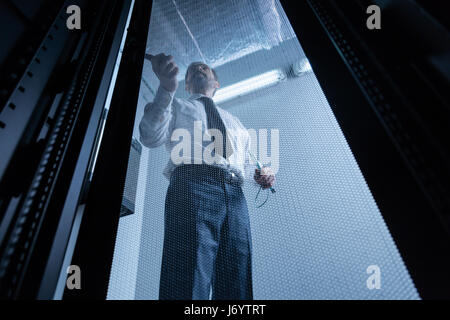 Handsome system administrator doing his job Stock Photo