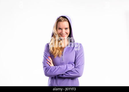 Young fitness woman in purple sweatshirt. Studio shot. Stock Photo