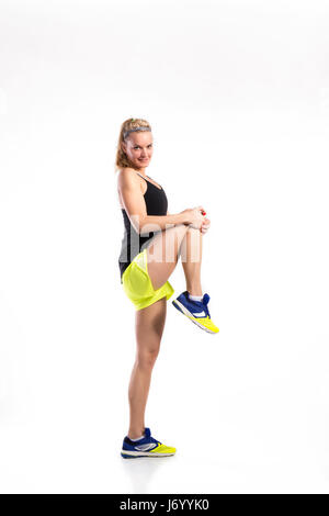 Attractive young fitness woman in black singlet. Studio shot. Stock Photo