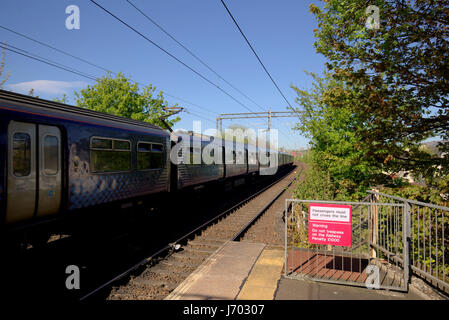 Scotrail train in station no trespassing on the railway sign Drumchapel Stock Photo