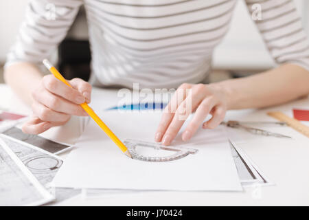 Skillful female engineer using a protractor Stock Photo