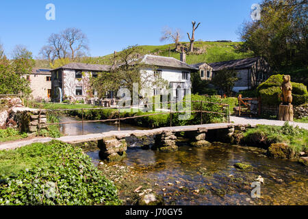 Old stone clapper bridge over Malham Beck to cafe. Malham, Malhamdale, Yorkshire Dales National Park, North Yorkshire, England, UK, Britain Stock Photo