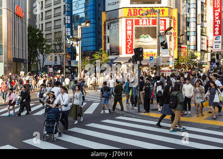 TOKYO - MAY 5, 2017: People walk across the streets in the very busy Shinjuku district in Tokyo, Japan capital city. Stock Photo