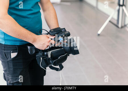 cameraman shooting with handheld camera Stock Photo