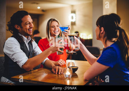 Group of friends toasting cocktails in a restaurant. Stock Photo