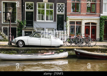 Old citroen ds sedan on a bridge over a canal in Amsterdam Stock Photo