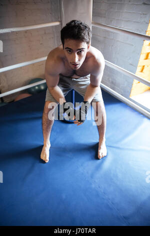 Top view of man boxer sitting in the corner of ring Stock Photo