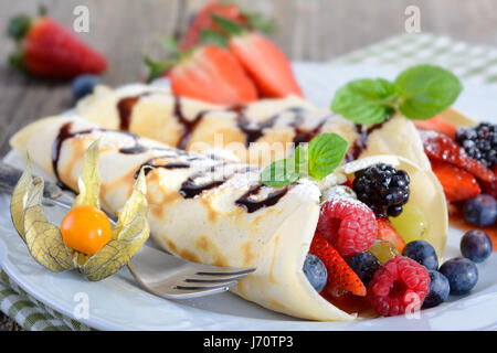 Two homemade pancakes stuffed with mixed fresh berries Stock Photo