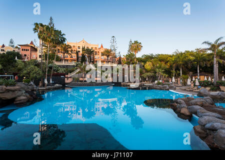 The five star hotel Bahia del Duque and swimming pool at the end of a day in Costa Adeje, Tenerife, Canary Islands, Spain Stock Photo