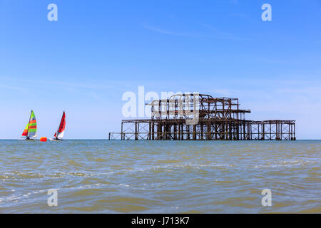 Sailing boats in the water near the old West Pier, Brighton, UK Stock Photo