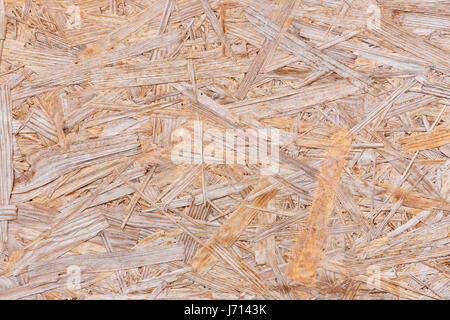 Background of pressed sawdust. Macro shot of wood particle board Stock Photo