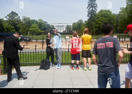 tourists take selfies outside security barriers on the south lawn of the white house Washington DC USA Stock Photo