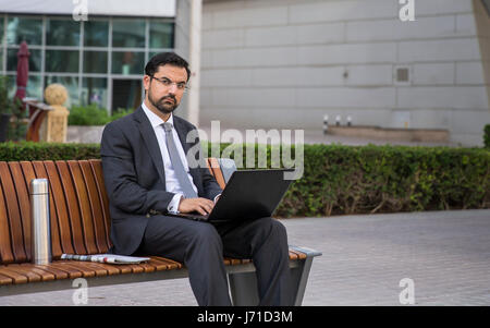 Businessman with  a computer outdoors Stock Photo