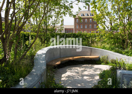 London, UK. 22nd May, 2017. A circular seating area of wood and stone surrounded by trees and flowers in the Joe Whiley Scent Garden at the RHS Chelsea Flower Show, May 22, 2017, London, UK Credit: Ellen Rooney/Alamy Live News Stock Photo