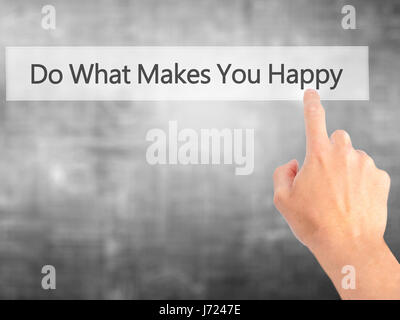 Do What Makes You Happy - Hand pressing a button on blurred background concept . Business, technology, internet concept. Stock Photo Stock Photo