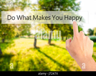 Do What Makes You Happy - Hand pressing a button on blurred background concept . Business, technology, internet concept. Stock Photo Stock Photo