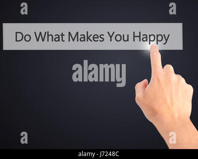 Do What Makes You Happy - Hand pressing a button on blurred background concept . Business, technology, internet concept. Stock Photo Stock Photo