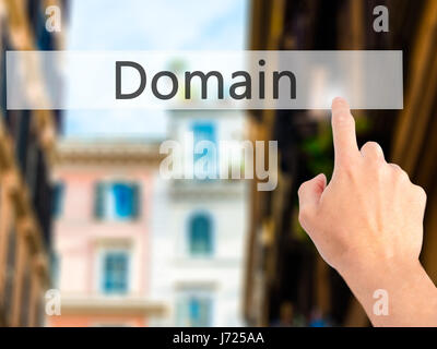 Domain - Hand pressing a button on blurred background concept . Business, technology, internet concept. Stock Photo Stock Photo