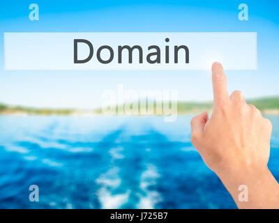 Domain - Hand pressing a button on blurred background concept . Business, technology, internet concept. Stock Photo Stock Photo
