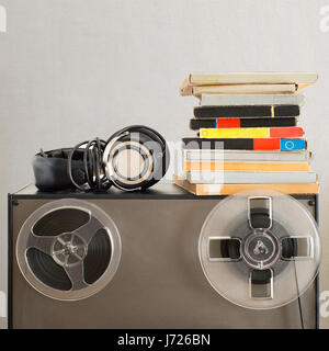 Vintage magnetic audio reels and headphones on the analog tape recorder Stock Photo
