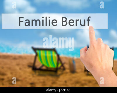 Familie Beruf (Family Occupation in German) - Hand pressing a button on blurred background concept . Business, technology, internet concept. Stock Pho Stock Photo