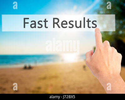 Fast Results - Hand pressing a button on blurred background concept . Business, technology, internet concept. Stock Photo Stock Photo