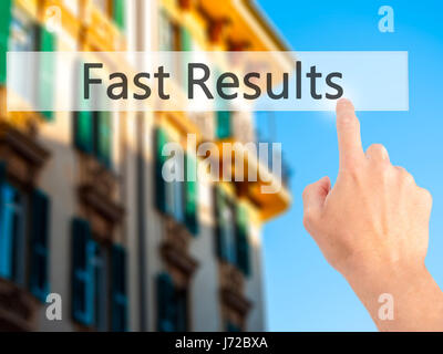 Fast Results - Hand pressing a button on blurred background concept . Business, technology, internet concept. Stock Photo Stock Photo