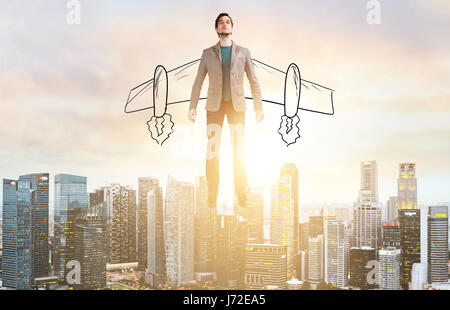 Business man hover over city skyline Stock Photo