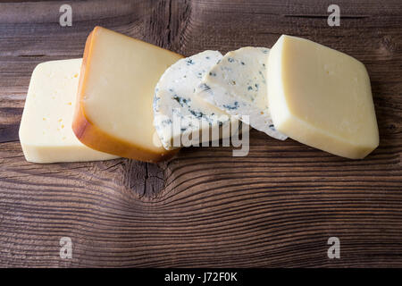 Different types of cheeses on wooden table Stock Photo