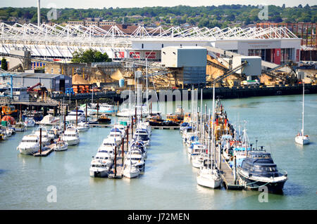 Boats towed at Itchen Marine Towage with the St Mary's Football Stadium in the background in Southampton in 2017, UK Stock Photo