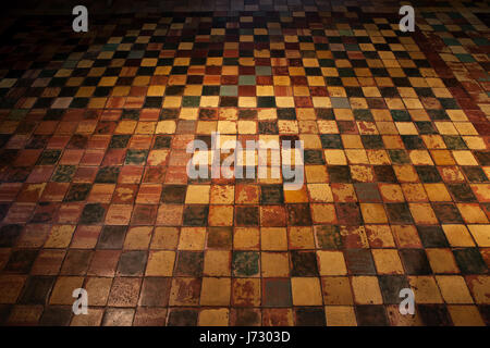 Grunge spooky creepy vintage tiled floor background from medieval Malbork Castle chamber, Poland, Europe Stock Photo