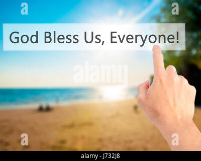 God Bless Us, Everyone - Hand pressing a button on blurred background concept . Business, technology, internet concept. Stock Photo Stock Photo