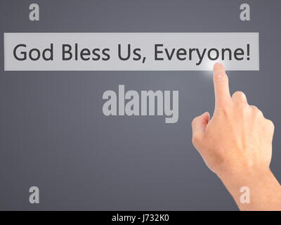 God Bless Us, Everyone - Hand pressing a button on blurred background concept . Business, technology, internet concept. Stock Photo Stock Photo