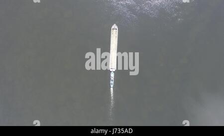 Long barge floating on the Dnieper river. Aerial view. Top view