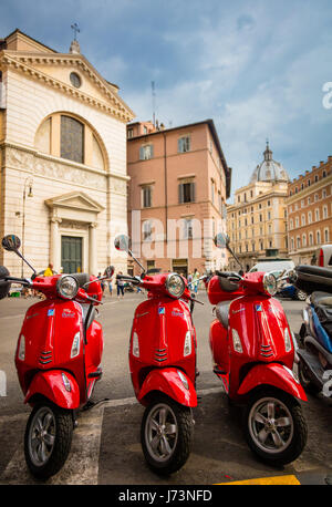 Three red Vespas on Piazza di San Pantaleo in Rome, Italy Stock Photo