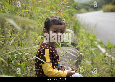 Small baby boy eating a biscuit Stock Photo