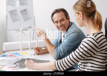 Positive professional engineer discussing work issues with his colleague Stock Photo