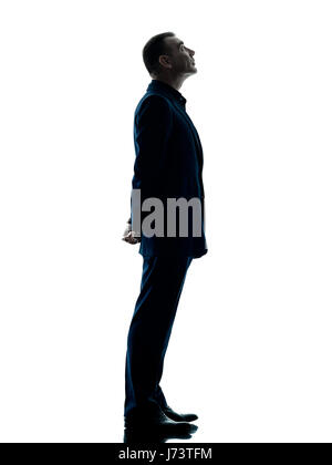 one caucasian business man standing profile silhouette isolated on white background Stock Photo