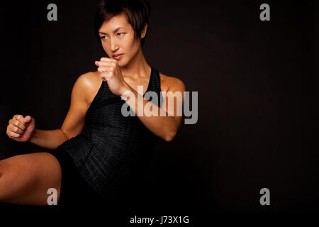 Portrait of woman practicing self defense. Stock Photo