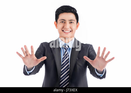 Asian man in black suit pushing blank virtual button on touch screen. Stock Photo