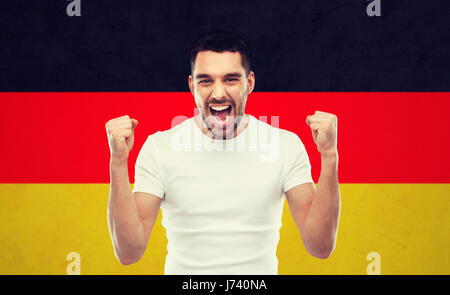 angry man showing fists over german flag Stock Photo