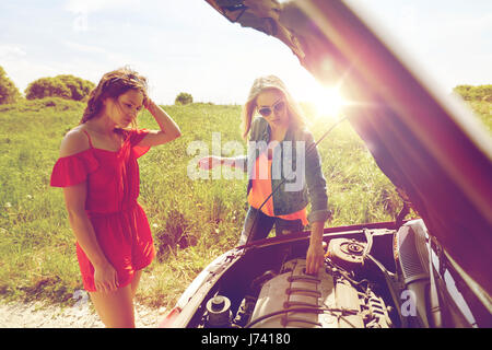 women with open hood of broken car at countryside Stock Photo