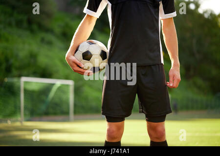 soccer player with ball on football field Stock Photo